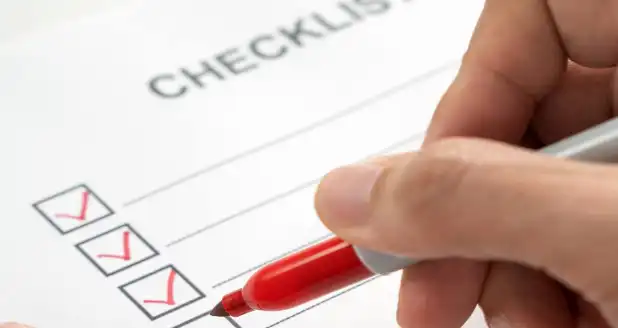Picture of hand checking off list post-divorce tasks
